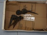 a cardboard box with a pair of scissors and a pair of pliers in it