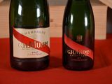 two bottles of champagne sitting next to each other on a table