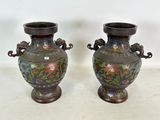 une paire de vases asiatiques ornés de motifs floraux, posés sur une table