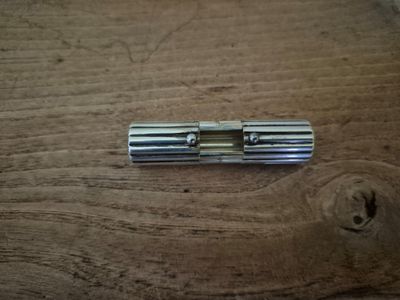 a small metal object on a wooden table