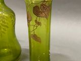 two green vases sitting next to each other on a table