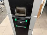 an image of a machine that is in a parking lot