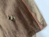 a small bird that is sitting in the pocket of a jacket