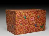 an orange box with a floral design on the front and sides