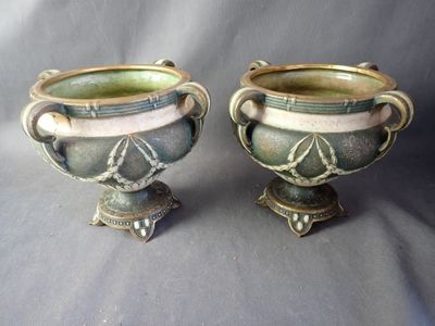 two vases sitting next to each other on a table