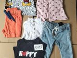 a lot of clothes that are laying out on a cardboard box