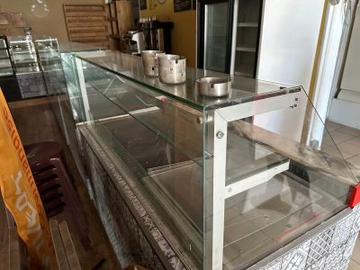 a glass display case in the middle of a kitchen