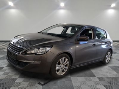 the grey car is parked on a checkered floor in the garage