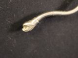 a metal hook that has a small piece of metal on it