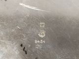a close up of a silver plate with a number on it