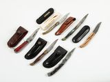 many different types of knives on a white surface