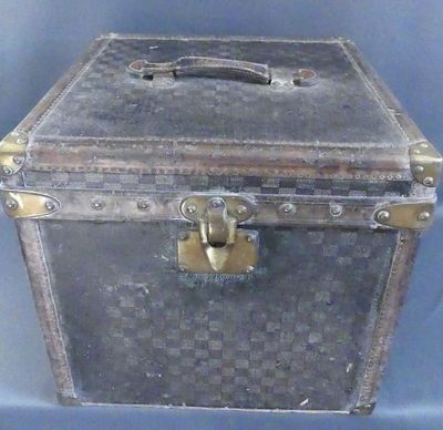 an old suitcase that is sitting on a blue surface