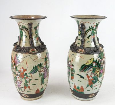 pair of chinese vases with oriental designs on them on a white background