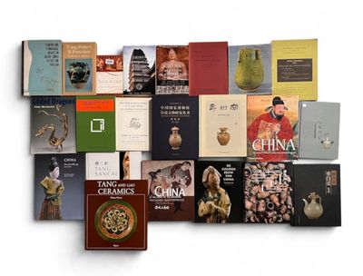 many books that are stacked together on a white surface