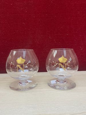 two wine glasses sitting next to each other on a table