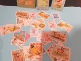 many stamps on a table with a blue table cloth