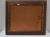 an old picture frame sitting on top of a white table