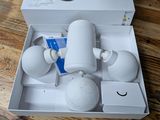a white box with a white cup and two cups in it on a table