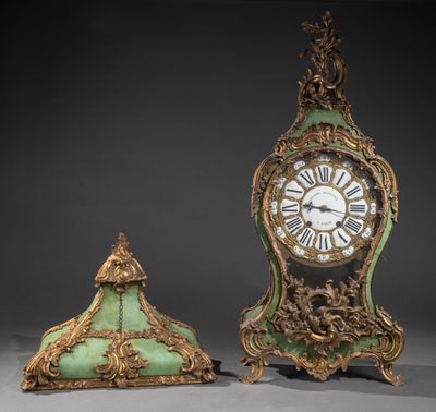 deux horloges vertes et dorées posées l'une à côté de l'autre sur une surface grise