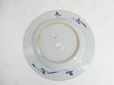 a white plate with blue flowers on it on a table