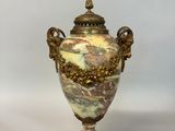 a vase that is sitting on a stand on a table