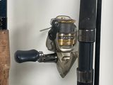a fishing rod and a spinning reel on a stand