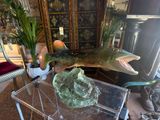 a fish that is sitting on top of a glass table