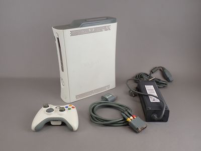 a video game console with a controller and a charger