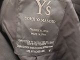 a close up of a person holding a jacket with a label on it
