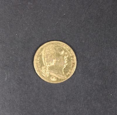gros plan d'une pièce d'or sur une surface noire