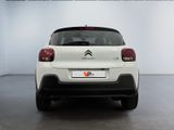 the rear of a white citrole car parked in a showroom