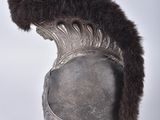 a silver helmet with a fur on top of it