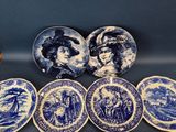 six blue and white plates with a picture of a man and woman on them