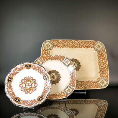 three plates that are sitting on a black table