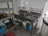 an image of a kitchen with a sink and shelves