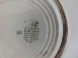 a close up of a white plate with a brown rim
