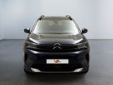 the front view of a black citrole parked in a room