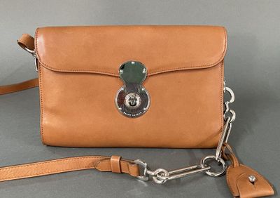 a close up of a brown purse with a chain around it