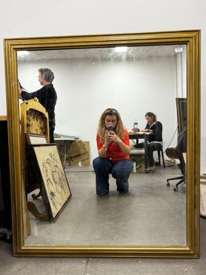 a woman taking a picture of herself in a mirror