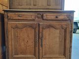 an old wooden cabinet with two doors and a drawer on top of it