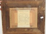 someone is holding a picture of a drawing in a wooden frame