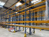a large warehouse with lots of shelves and pallets in it
