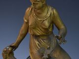 a statue of a woman sitting on top of a clock
