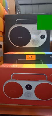 three boxes of different colors and sizes of speakers on the shelf