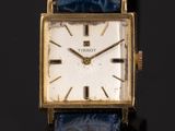 an image of a close up of a wrist watch with a blue strap