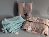 two blankets and a bag of blankets are sitting on a table