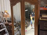a man standing in front of a large mirror in a room