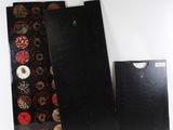 three pieces of black paper with red and gold designs on them