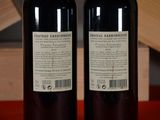 two bottles of wine sitting next to each other on a table
