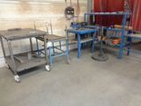several tables and carts in a room with a red wall